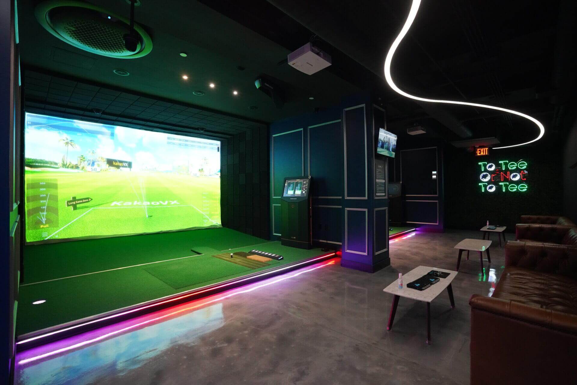 Kakao VX simulator bay with lounge seating and neon signage