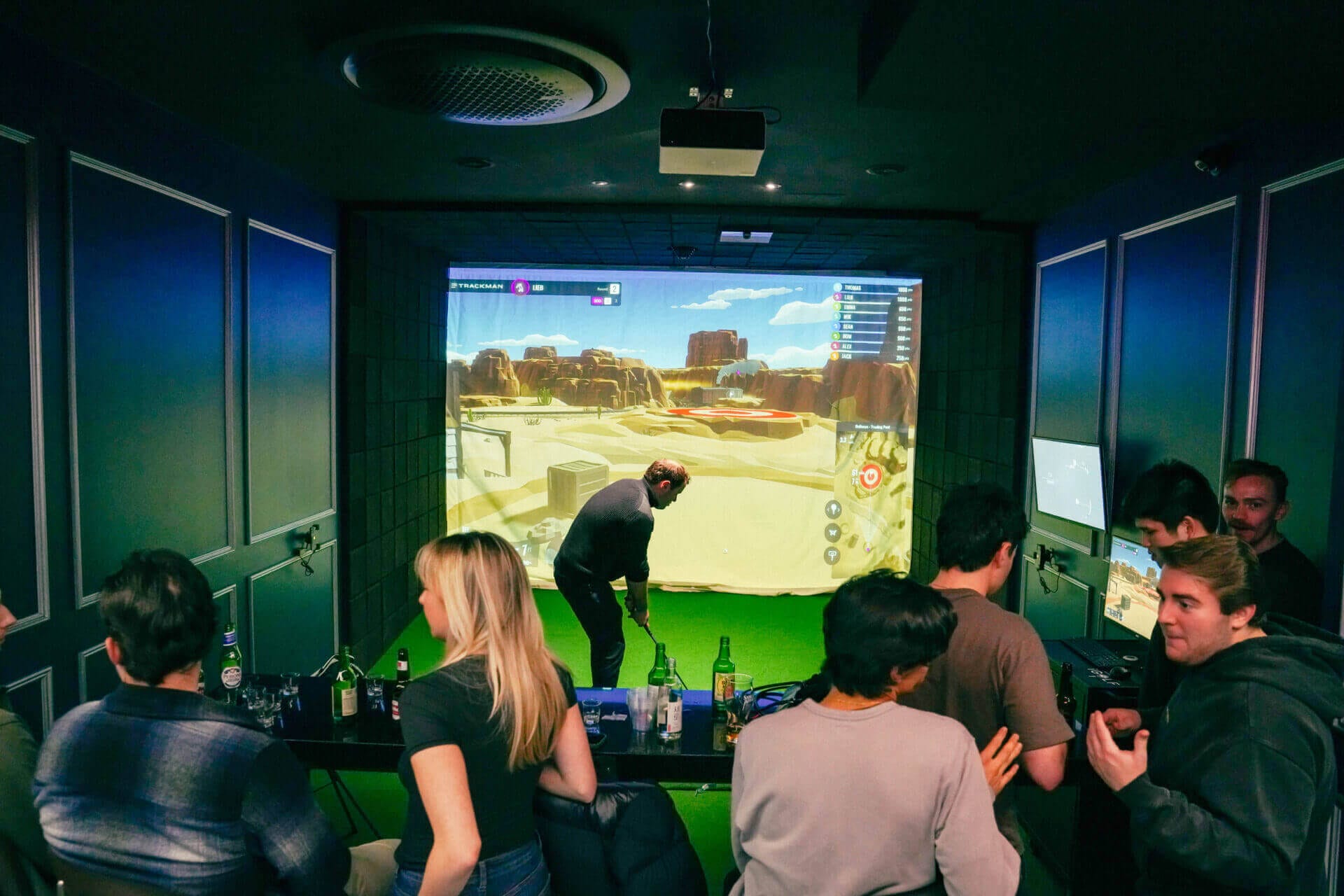 Group celebrating in a private simulator bay